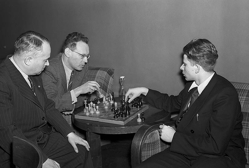 Moscow, 22nd February 1955. World Champion Mikhail Botvinnik and 18-year-old Boris Spassky analyse their drawn game from the 8th round of the 22nd USSR Championship, as grandmaster Salo Flohr looks on_griffin.
